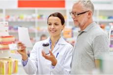pharmacist shows the medicine to the customer